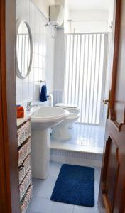 a bathroom with a sink and a toilet and a mirror at Tari Home Crotone in Crotone +12 photos