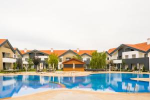 a large swimming pool with houses in the background at ZEPHYR Ifrane in Ifrane