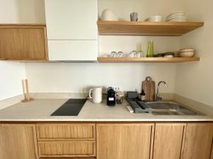 a kitchen with a sink and a counter top at MIRA MARE - Apartment 5 in Stavros +25 photos