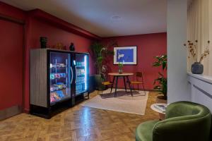 a living room with a refrigerator and a table at COVE Cannon Street in London
