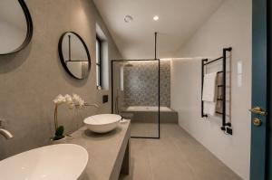 a bathroom with a sink and a toilet and a shower at 23 Boutique Hotel in Il-Furjana +70 photos