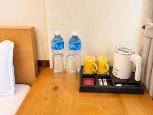 a tray with two bottles of water on a bed at Boudha Mandala Hotel in Kathmandu