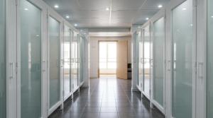 a hallway of glass doors in an office building at Residencia Universitaria Resa Sant Jordi in Tarragona