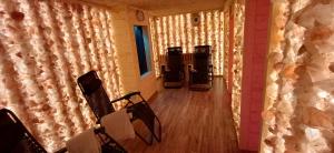 an empty room with chairs in a room with lights at Willa Krystal in Ciechocinek