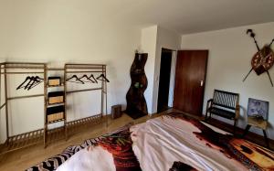 a bedroom with a bed and some clothing on the wall at Henneberger Hof Wildlife in Münnerstadt