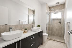 a bathroom with a sink and a toilet and a shower at Sara by Ready Set Stay in Caroline Springs