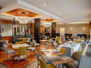 a dining room with tables and chairs and tablesktop at ZEPHYR Ifrane in Ifrane