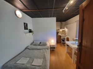 a room with two beds and a table in it at Villa Patria Wadowice in Wadowice +35 photos