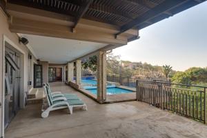 a patio with two chairs and a swimming pool at Stella Road 24 in Ballito
