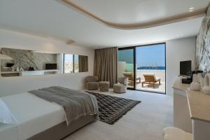 a bedroom with a bed and a living room at Tagoo Hills in Mikonos +269 photos