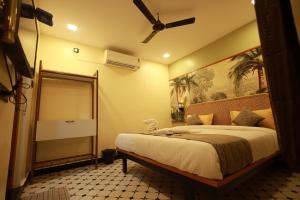 a bedroom with a bed and a ceiling fan at David Residency in Madurai