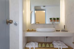 a bathroom with a sink and a mirror at Helestia Hotel, Caldera Santorini in Firostefani +43 photos