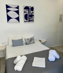 a bedroom with a bed with towels on it at Ione Inn in Naxos Chora +91 photos