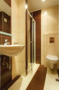 a bathroom with a sink and a toilet at Къща за гости ДИАМАНТ in Primorsko