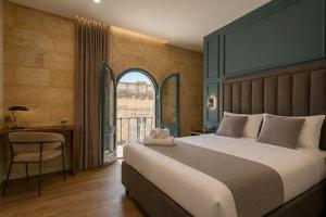 a bedroom with a large bed and a window at 23 Boutique Hotel in Il-Furjana