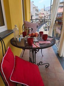 a table with a bowl of fruit on a balcony at Case Borgo Vacanze in Letojanni
