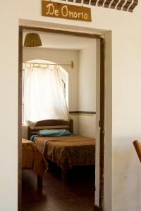 a bedroom with a bed with a sign that reads be ontario at Hostería - Bodega Valle Divino in Uriondo