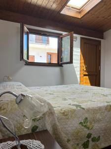 a bedroom with a bed and a window at B&B Casa Torre -Amalficoast room in Agerola