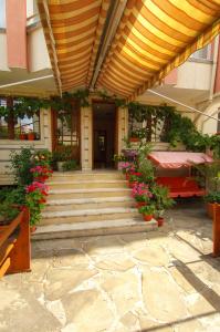 a building with stairs and flowers in front of it at Къща за гости ДИАМАНТ in Primorsko