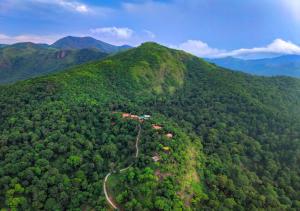 an aerial view of a mountain with a road at Celestial Heights Coorg by VOYE HOMES with Sunset views-Near to Nagarhole Tiger Reserve in Srimangala