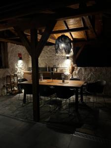 a dining room with a wooden table and chairs at Valmont Luxury Chalet in Glozhene