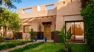a house in the middle of a yard at Villa AG Marrakech in Marrakesh