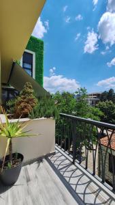 a balcony with potted plants on a building at ABC Apartments in Korçë