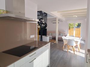 a kitchen and living room with a table and chairs at Hamabi in Hendaye