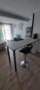 a large table with a stool in a room at La cigala in Le Pradet +7 photos