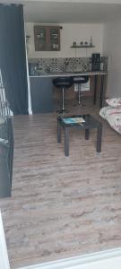 a living room with a table and a kitchen at La cigala in Le Pradet