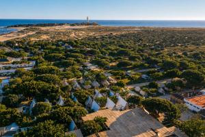 an aerial view of a village on the beach at Kampaoh Hostel Trafalgar in Los Caños de Meca