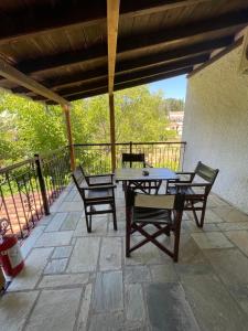 a patio with a table and chairs on a patio at Saily Beach Hotel in Koropi