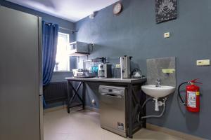 a small kitchen with a sink and a counter at Hostel IRON CUBE in Stružná +83 photos