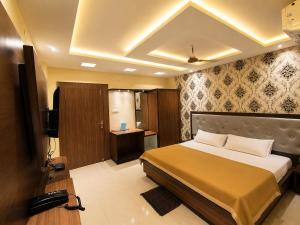 a hotel room with a bed and a television at Hotel Baikuntha International Puri Near Sea Beach With Parking AC Or Non AC Both Room in Puri