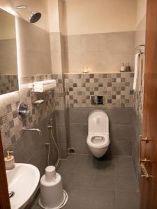 a bathroom with a toilet and a sink at Hotel Baikuntha International Puri Near Sea Beach With Parking AC Or Non AC Both Room in Puri