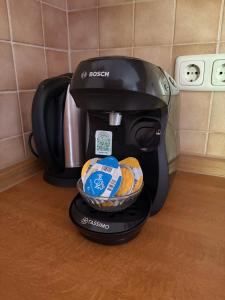 a black coffee maker with a basket of food at Ferienwohnungen an der RupertusTherme in Bad Reichenhall