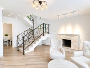 a living room with a staircase and a fireplace at Crown Villa Bakuriani in Bakuriani +20 photos
