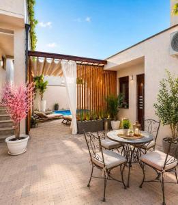 a patio with a table and chairs and a pool at Villa Diamond in Mostar
