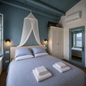 a bedroom with a bed with two towels on it at Chalet Como Lake - Nature Retreat, foot access only in Griante Cadenabbia