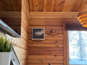a wood paneled wall in a tiny house at Charmig timmerstuga i Vemdalen in Vemhån +4 photos