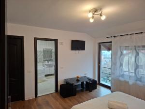 a bedroom with a bed and a view of a bathroom at Pensiunea Turist in Techirghiol