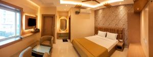 a small bedroom with a bed and a window at Hotel Baikuntha International Puri Near Sea Beach With Parking AC Or Non AC Both Room in Puri +15 photos