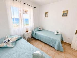 a bedroom with two beds and a window at Mirador de las Gaviotas in Mojácar +34 photos