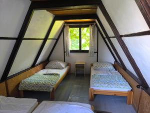 a room with two beds and a window at Kemp Prachovská osma in Libuň