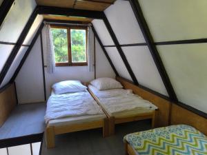 two beds in a small room with a window at Kemp Prachovská osma in Libuň +147 photos