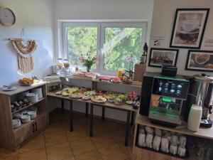 a kitchen with a counter with plates of food at Willa Domiwera in Polańczyk