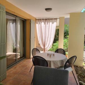 a dining room with a table and chairs at La Calade in L'Isle-sur-la-Sorgue