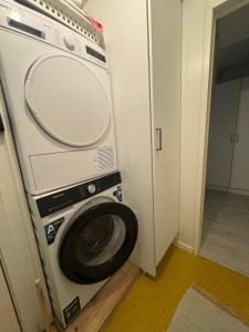 a washer and dryer in a small room at House on the lake in Bogen