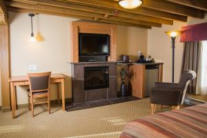 a hotel room with a bed and a television and a fireplace at Murray Premises Hotel in St. John's