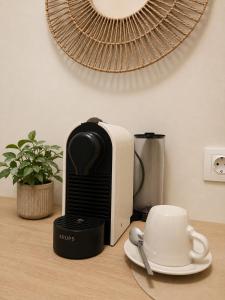 a coffee maker sitting on a counter next to a cup at Lithos in Palaiochora